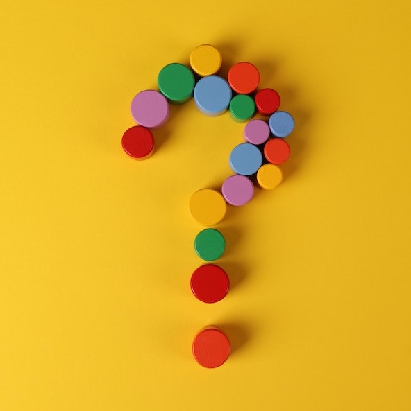 Website Refresh or Website Redesign? Colorful Question mark made up of red, green, blue, yellow and orange round objects.